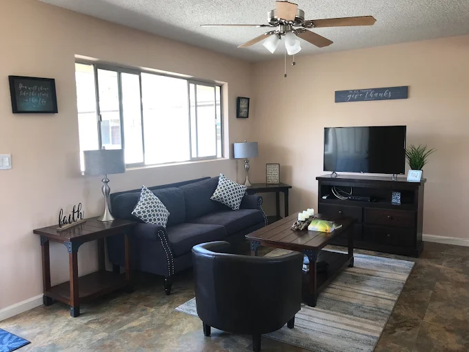 Living room with sofa, TV, and coffee table.