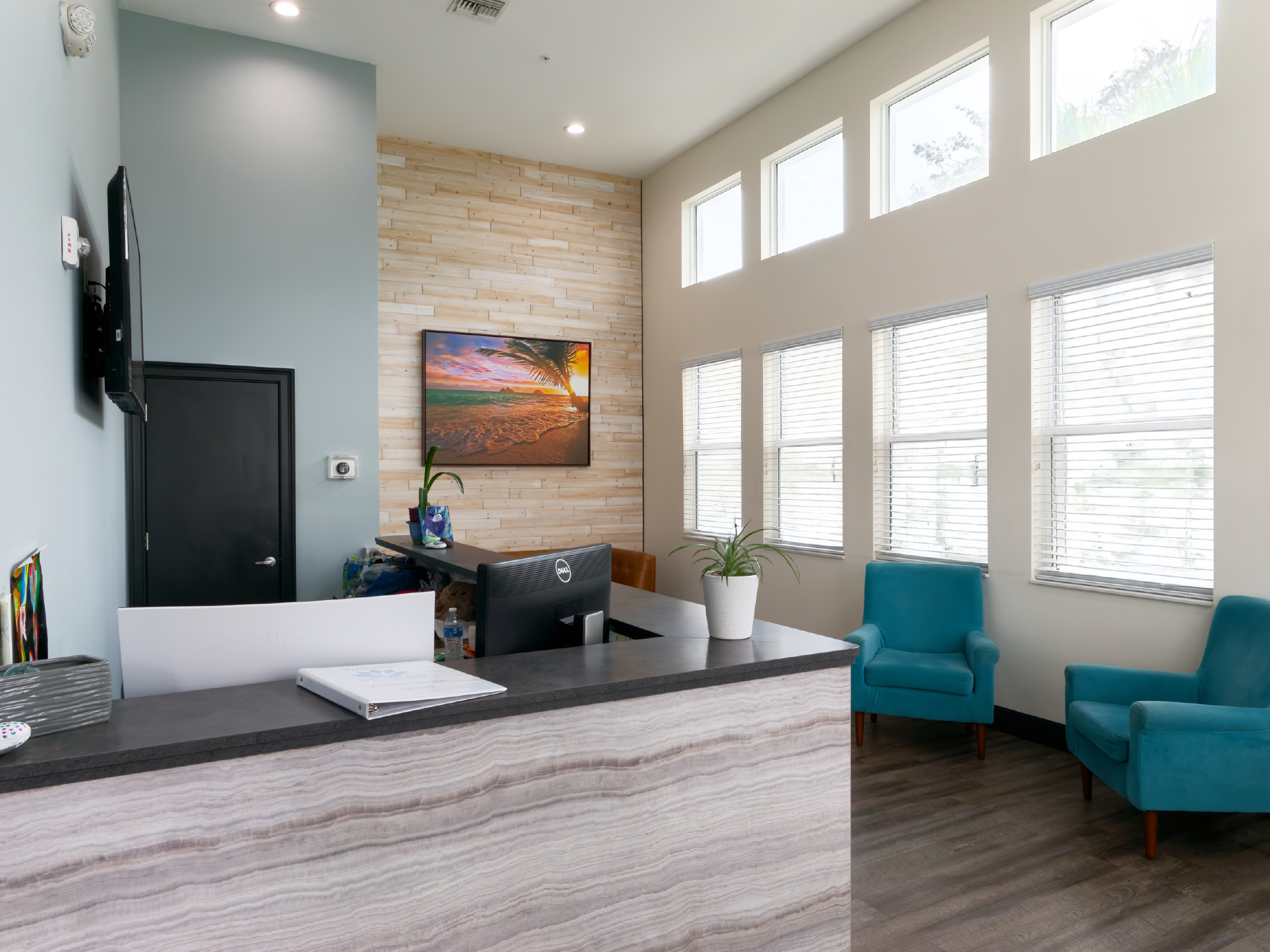 Bright medical lobby with reception desk and chairs
