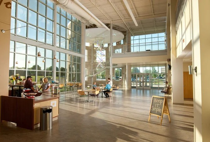 Bright lobby with seating, large windows, and reception area