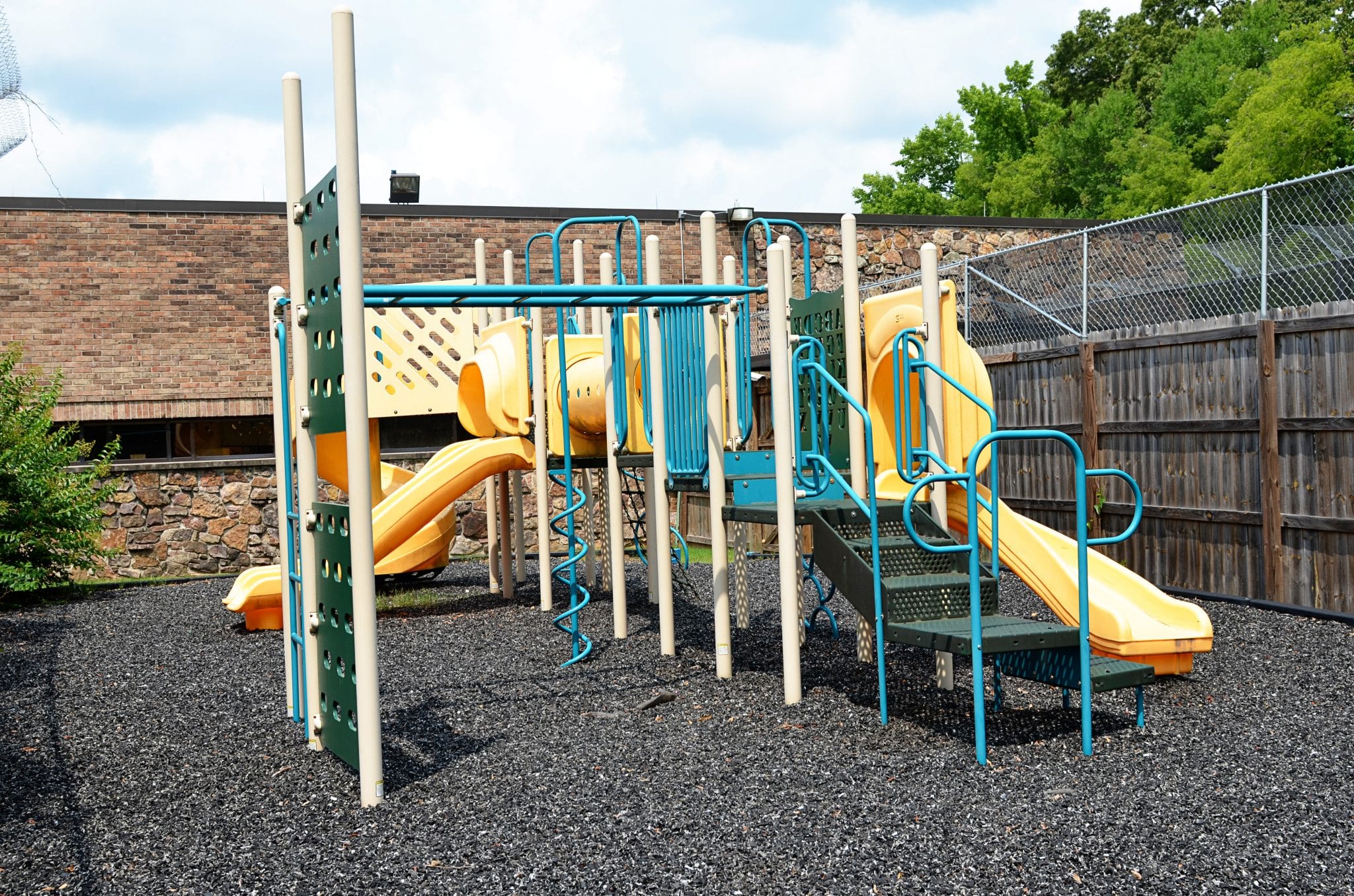 Secure outdoor playground with slides and climbing equipment