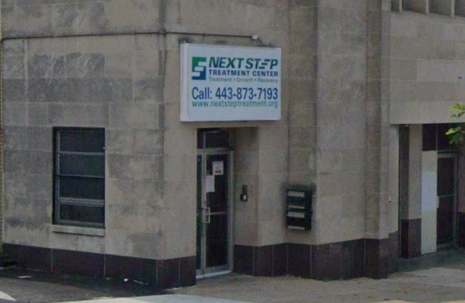 Street-level view of rehab entrance with center sign.