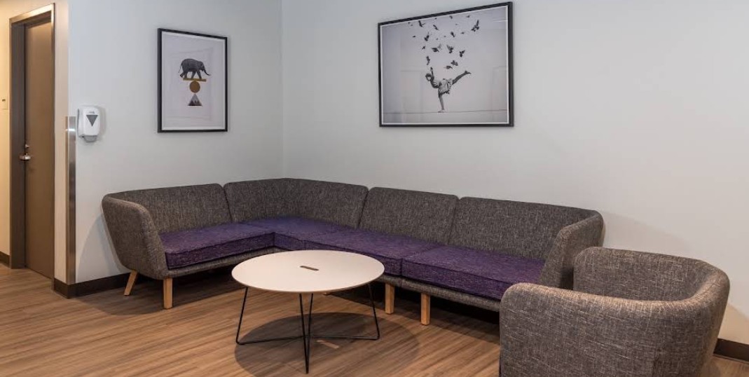 Community lounge with sectional seating and artwork