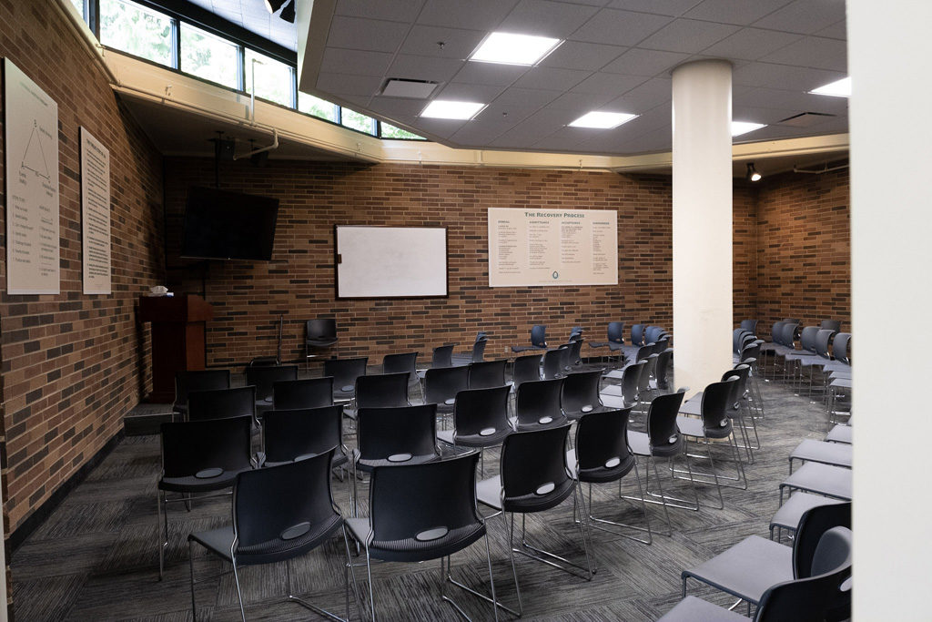 Group therapy room with chairs and presentation board