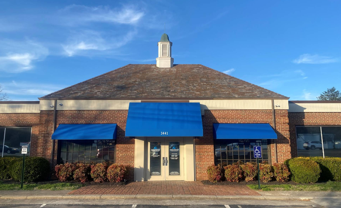 Brick building exterior with blue awnings