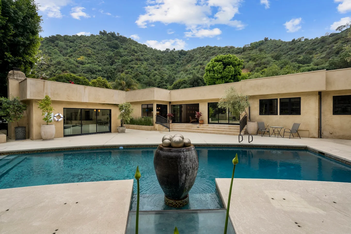 Swimming pool with mountain view and patio seating