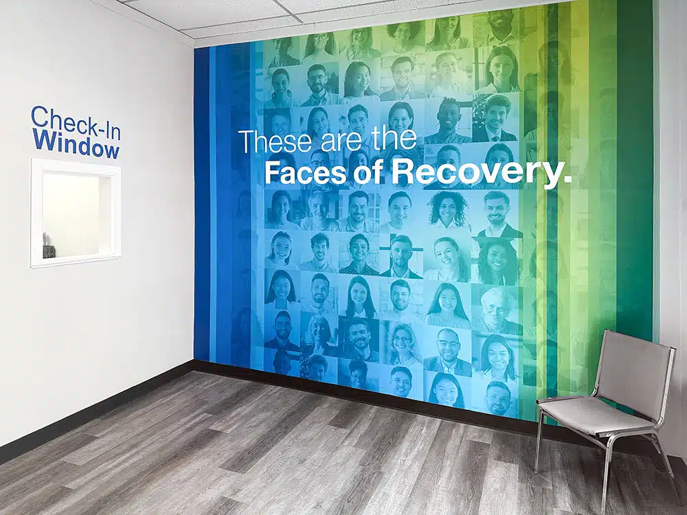 Faces of Recovery mural near check-in window and seating