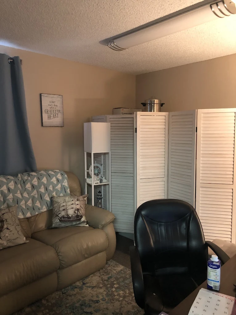 Treatment room with beige sofa and privacy divider