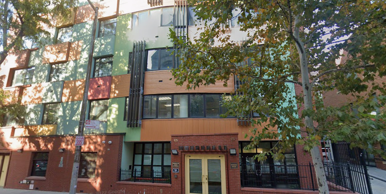 Colorful rehab facility exterior with trees and front entrance