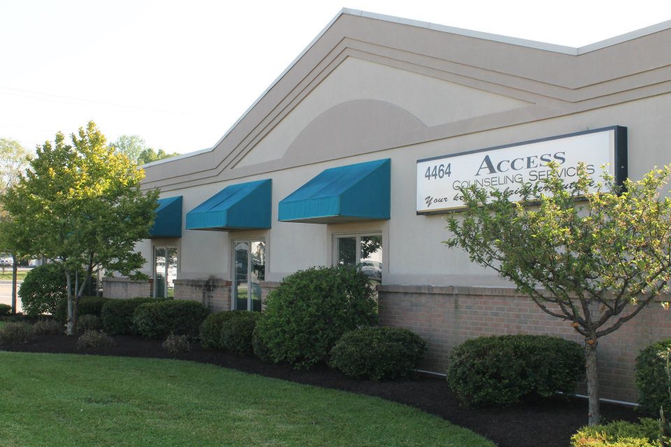 Front exterior of Access Counseling Services LLC in Franklin OH with building sign and green awnings