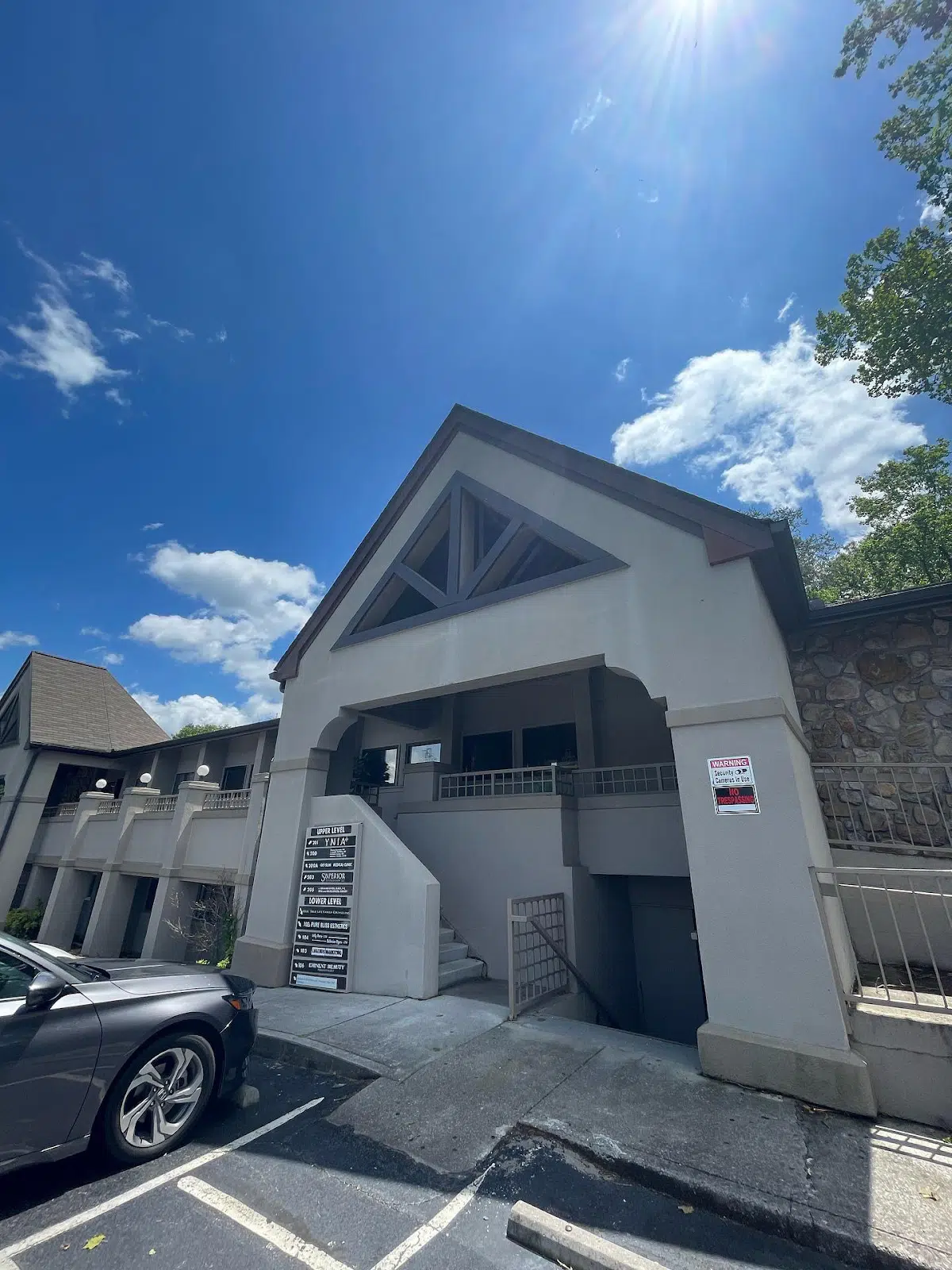 Two-story building with stairs and parking area