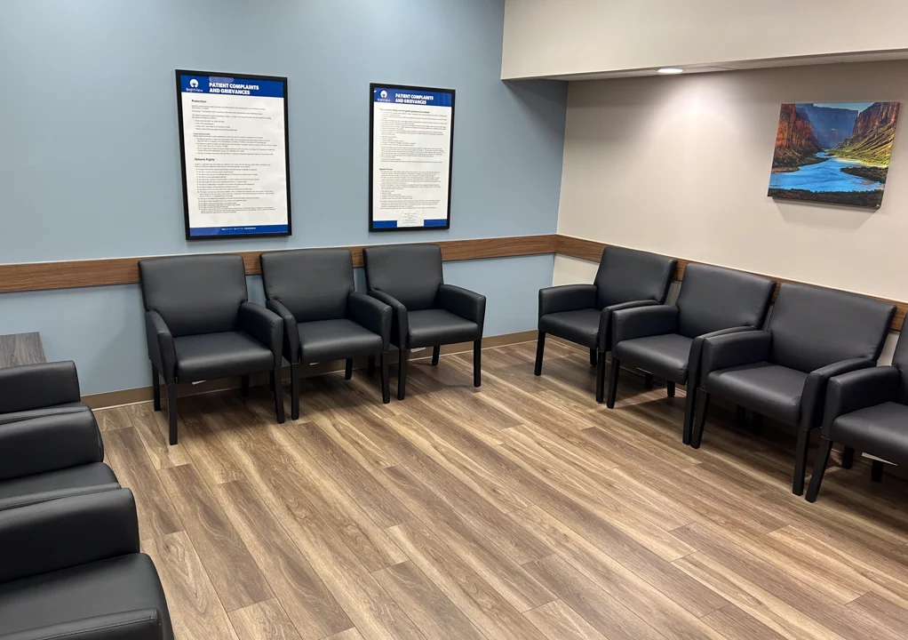 Waiting room with black chairs arranged along the walls