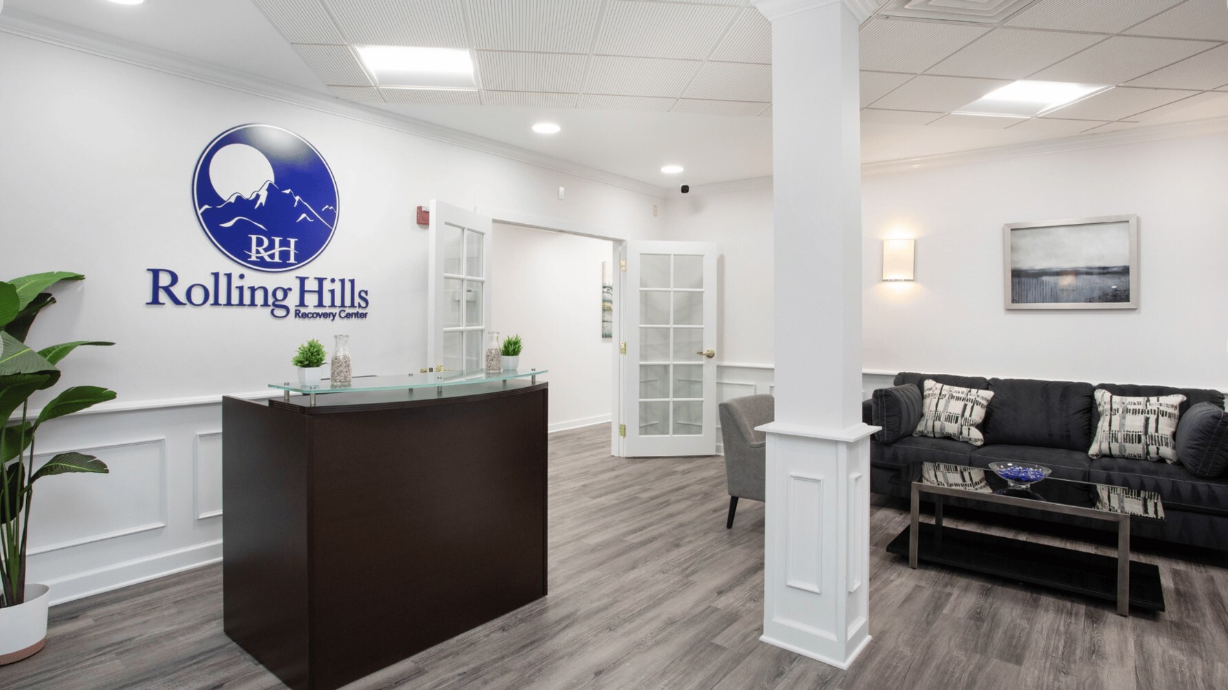 Rolling Hills reception with a couch and chairs by the desk.