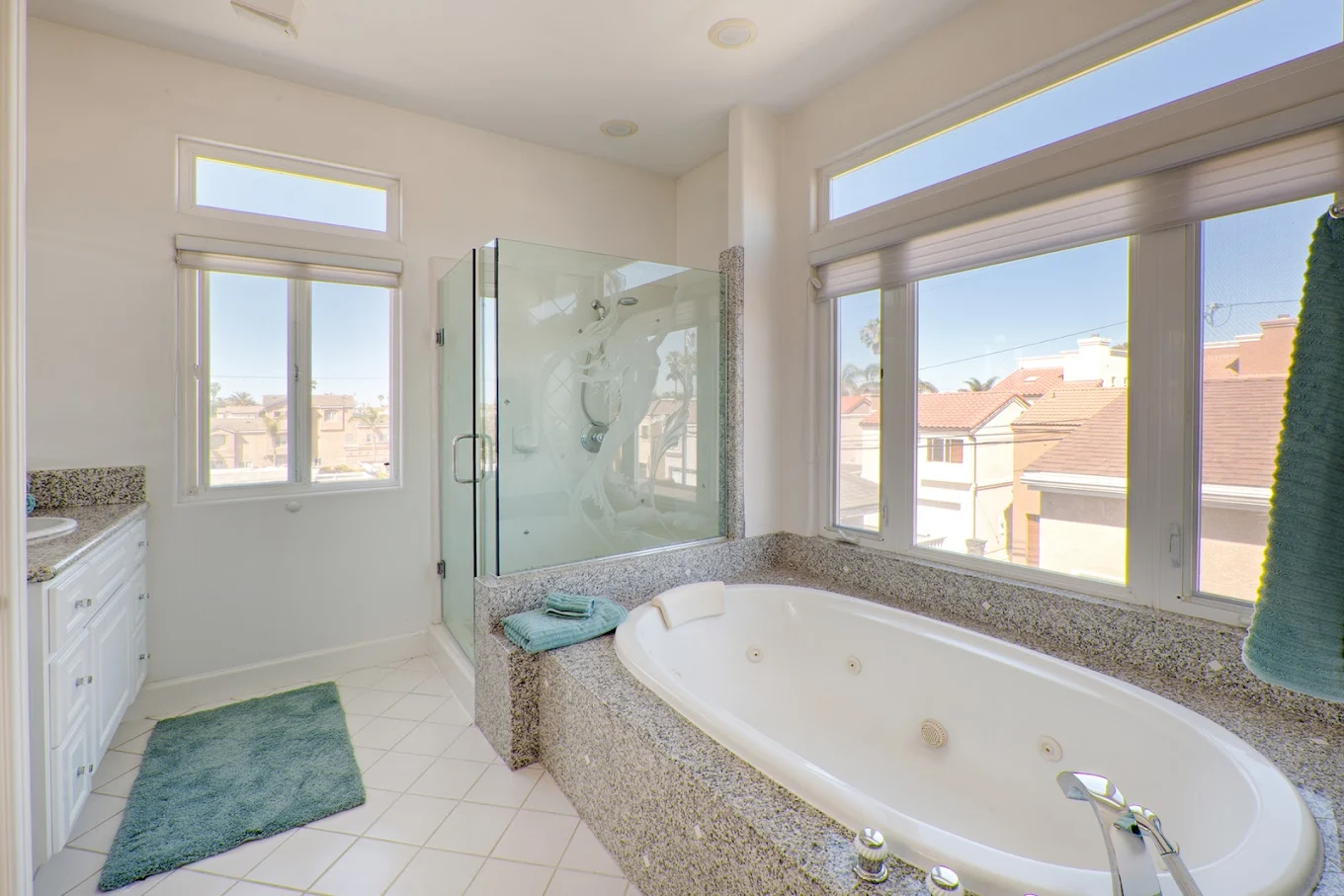 Bright bathroom with jacuzzi tub and glass shower