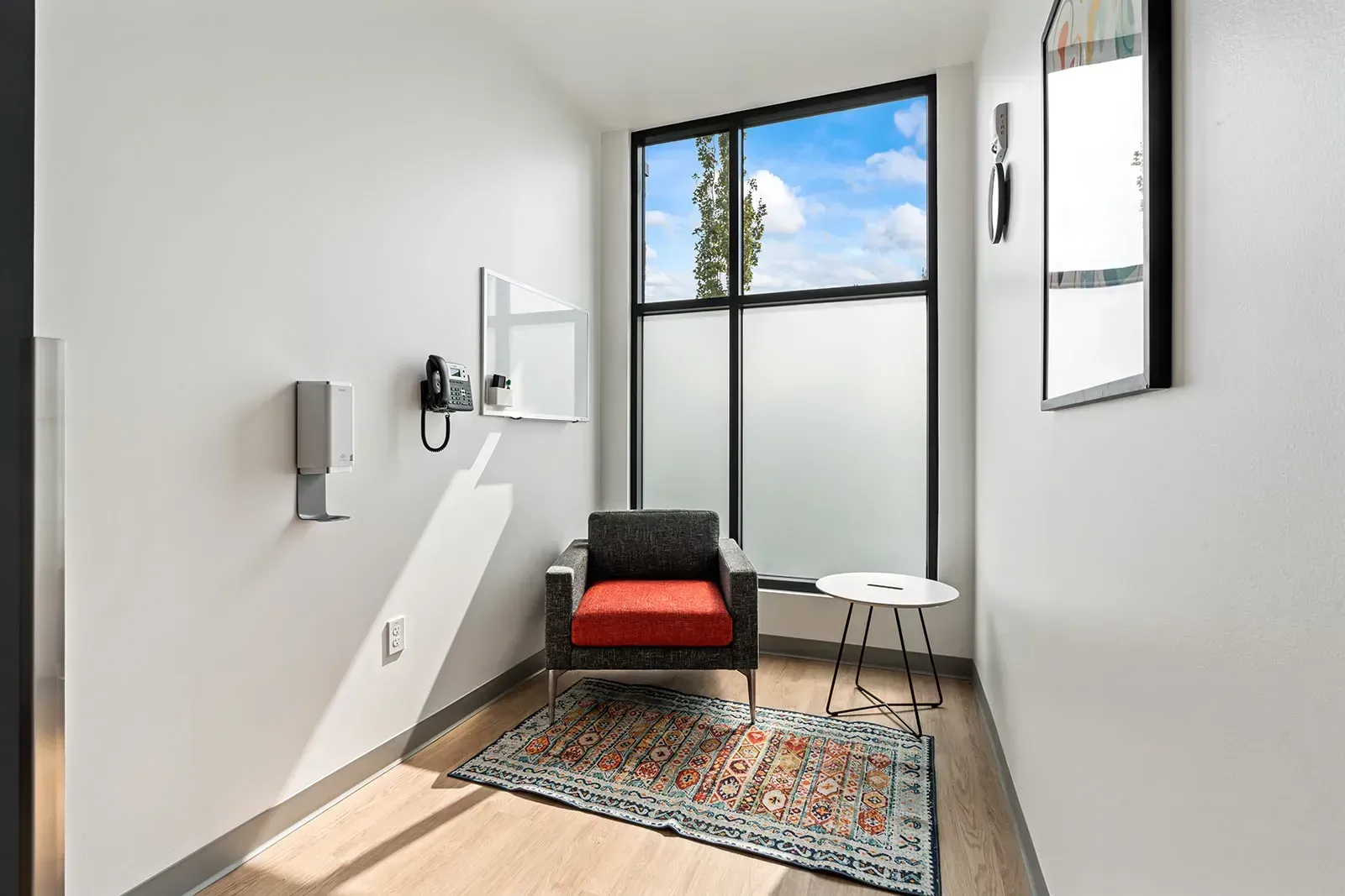 Quiet phone room with chair, table, and large window