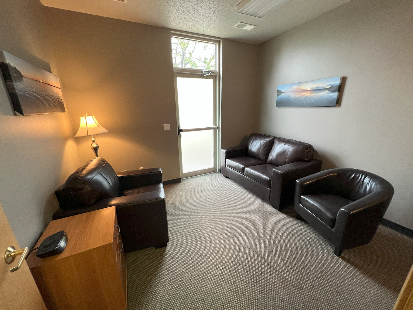 Cozy therapy room with sofas and a standing lamp
