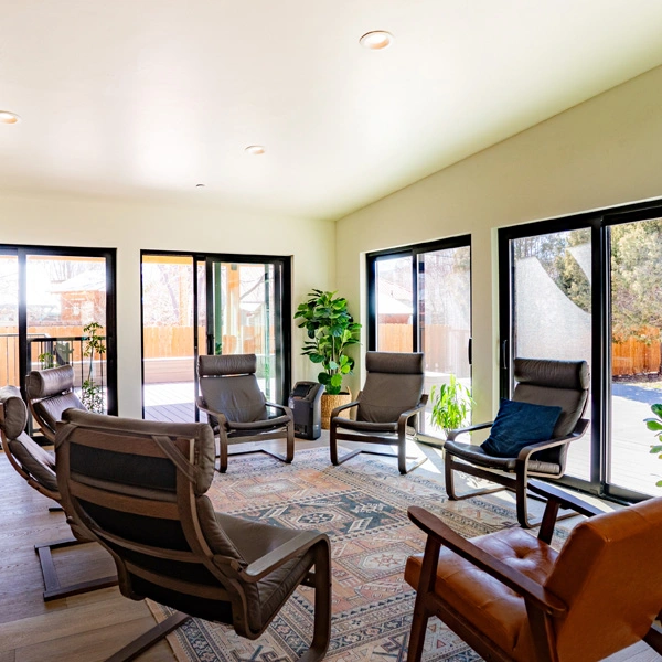 Bright room with circle of chairs for group therapy