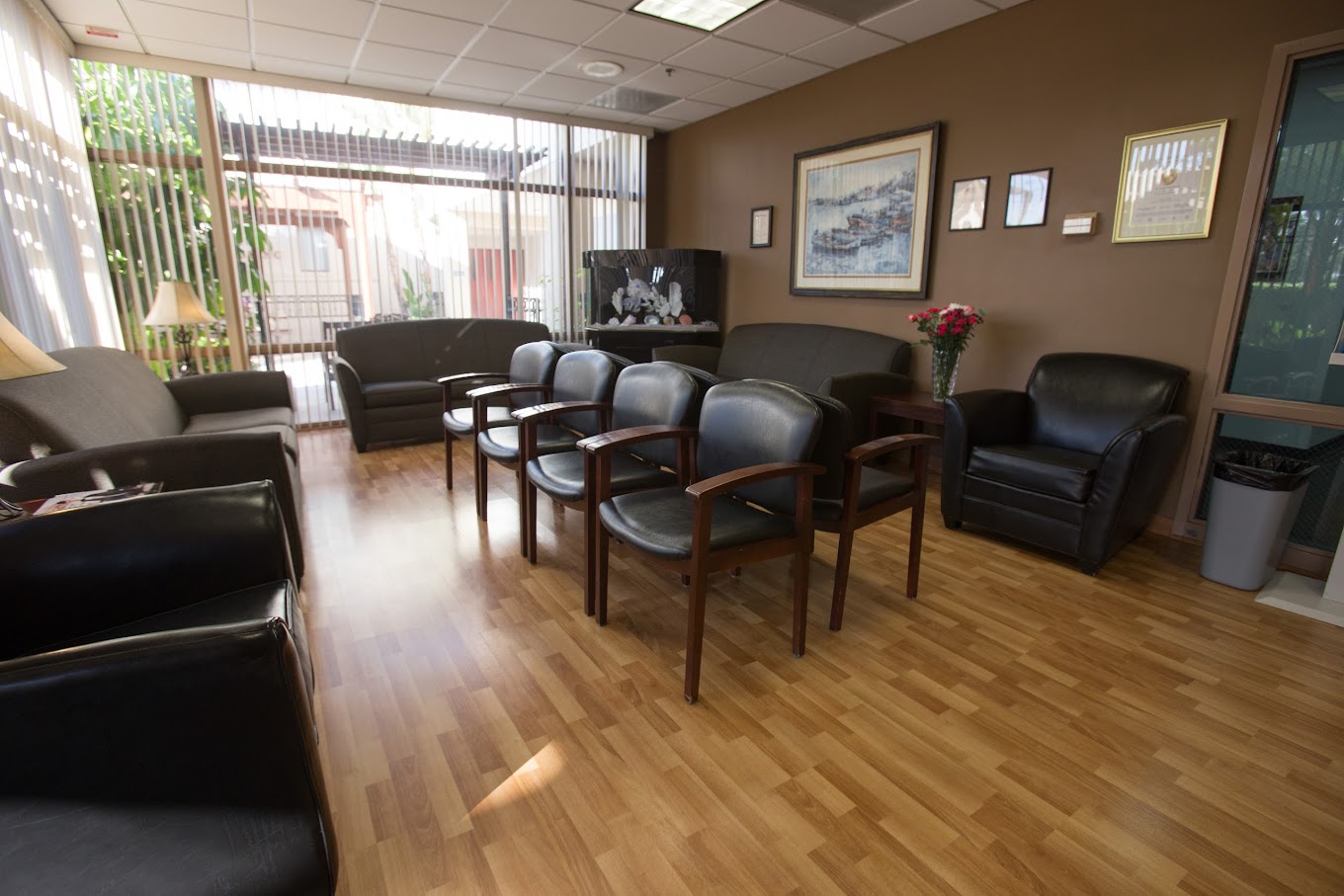 A warm and inviting waiting area with comfortable seating, natural light, and tasteful decor, offering a relaxing and pleasant space.