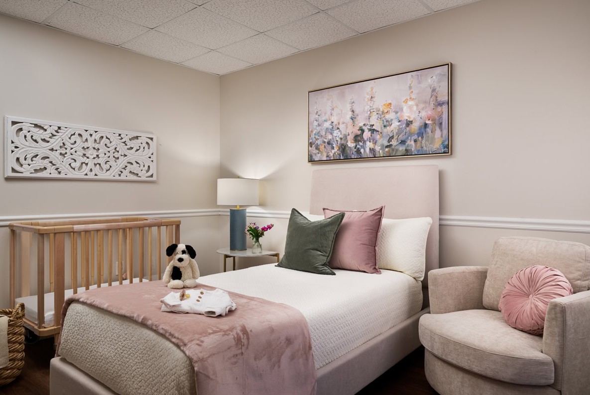 Soft-toned bedroom with crib and chair for mother and baby