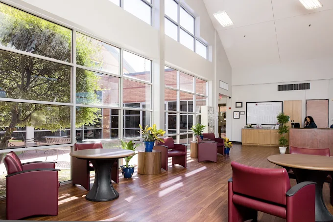 Bright lobby with seating and floor-to-ceiling windows