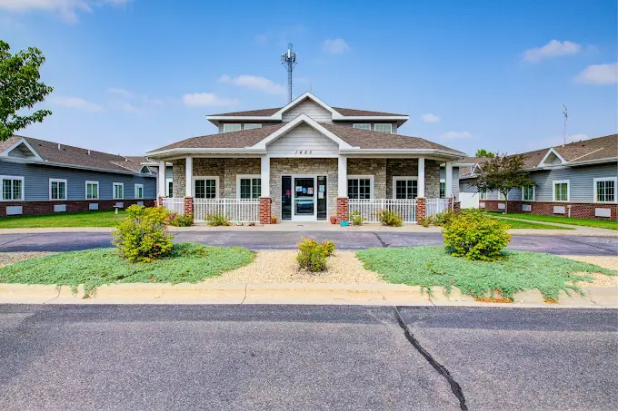 Front view of the main facility with porch and landscaping
