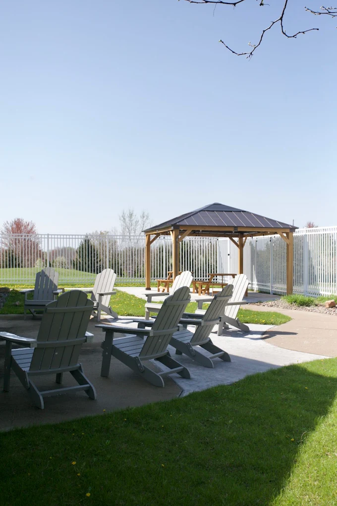 Outdoor patio with Adirondack chairs and covered gazebo