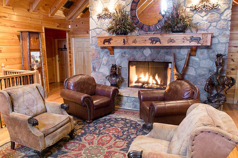Seating area with leather chairs and stone fireplace