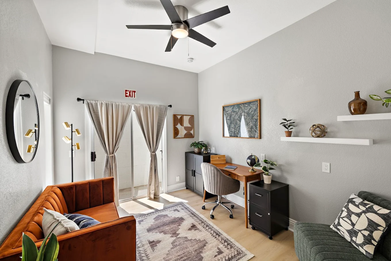 Private therapy room with sofas, desk, and office chair