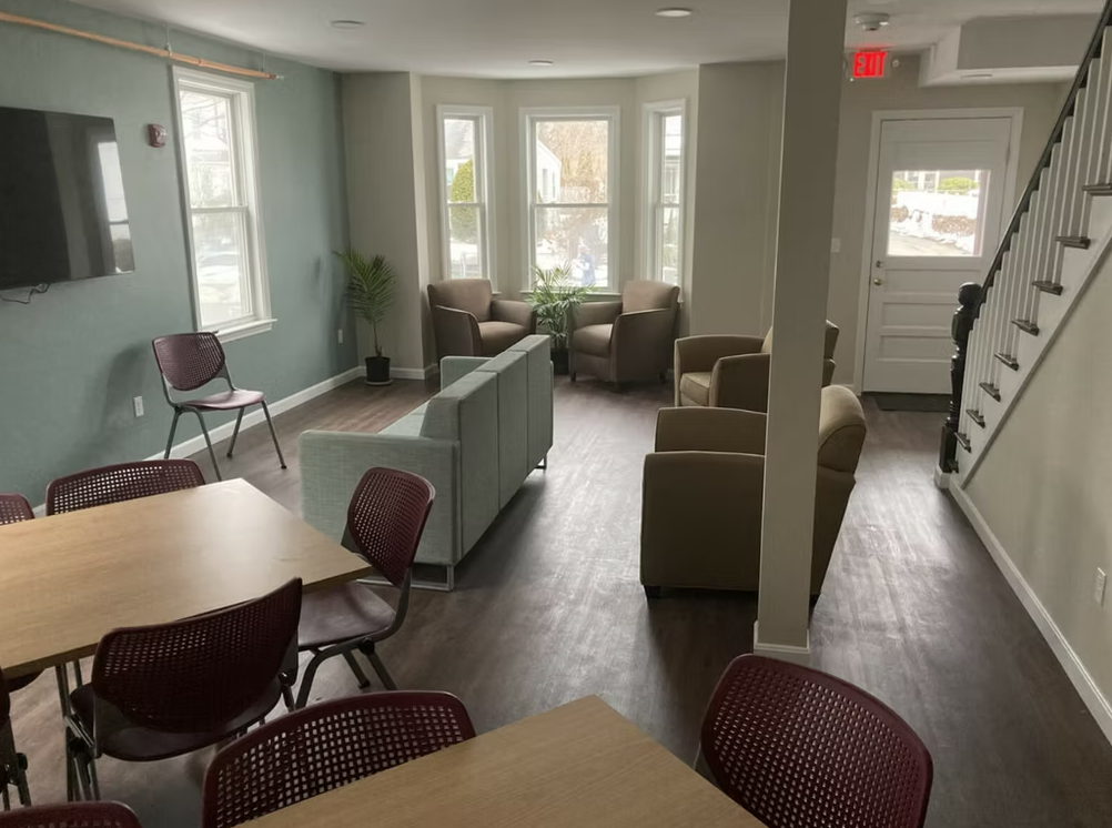 Indoor group therapy space with seating and tables