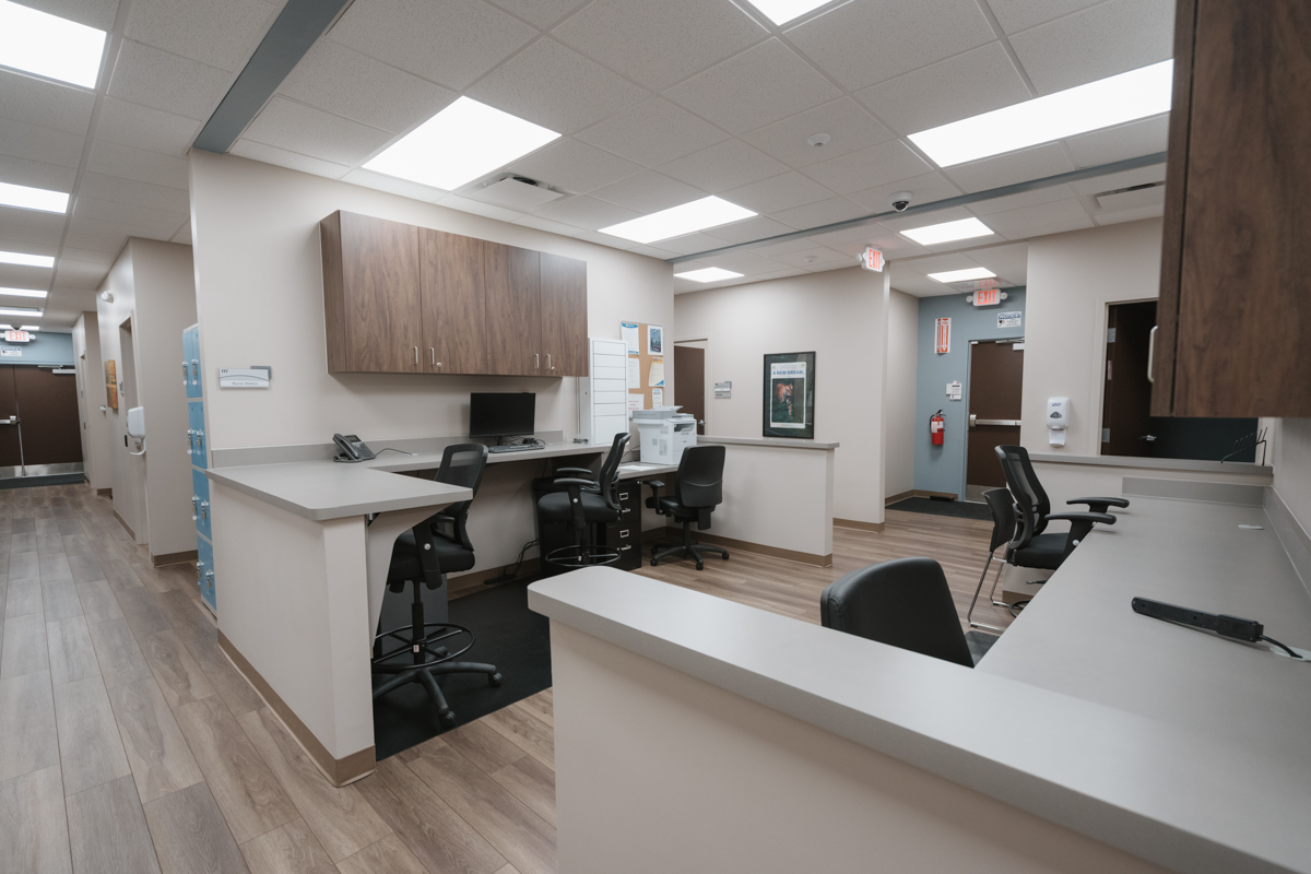 Nurses station with work counters, chairs, and cabinets