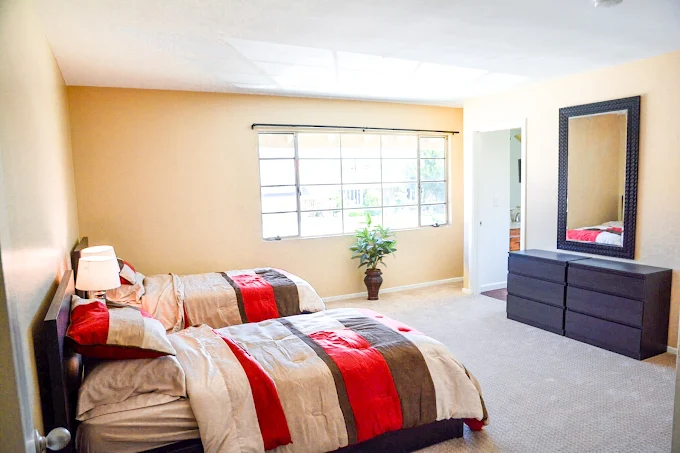 Bright twin bedroom with colorful bedding and dresser