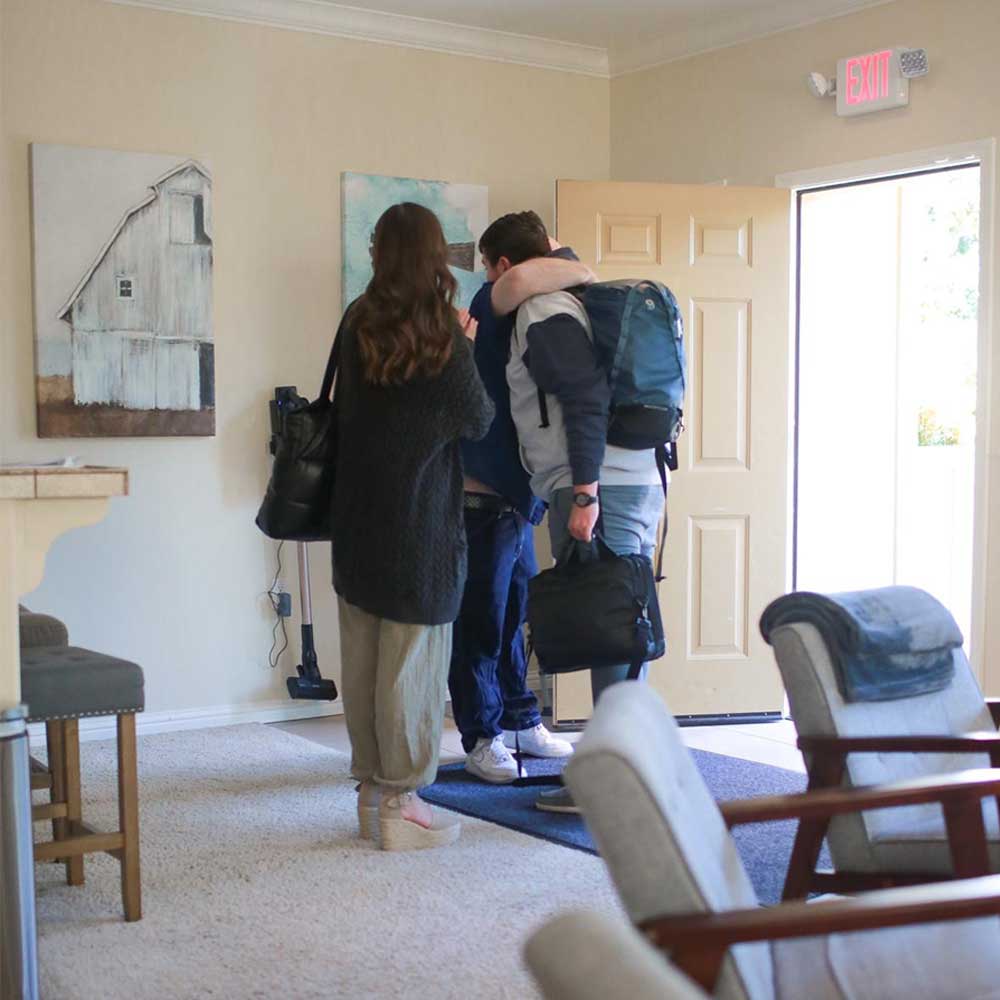 Family hug at entrance during rehab intake arrival