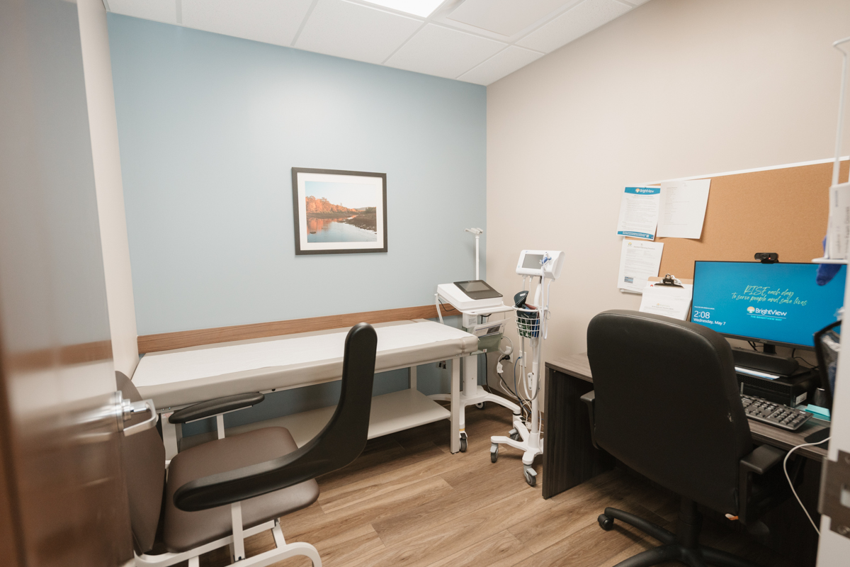 Exam room with treatment table, computer, and medical equipment