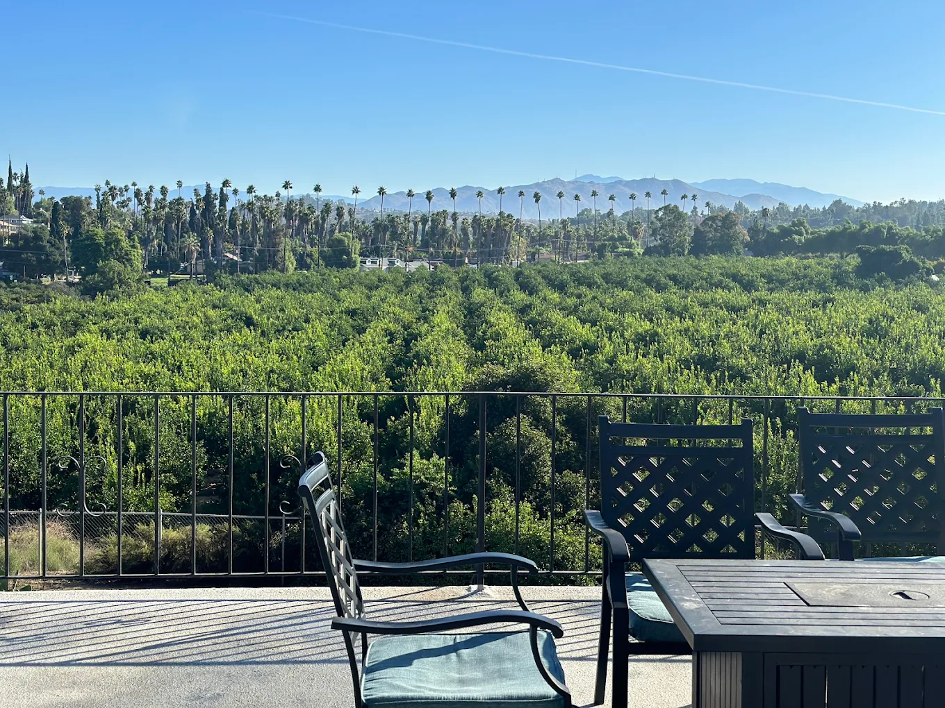 Outdoor patio overlooking mountains and trees