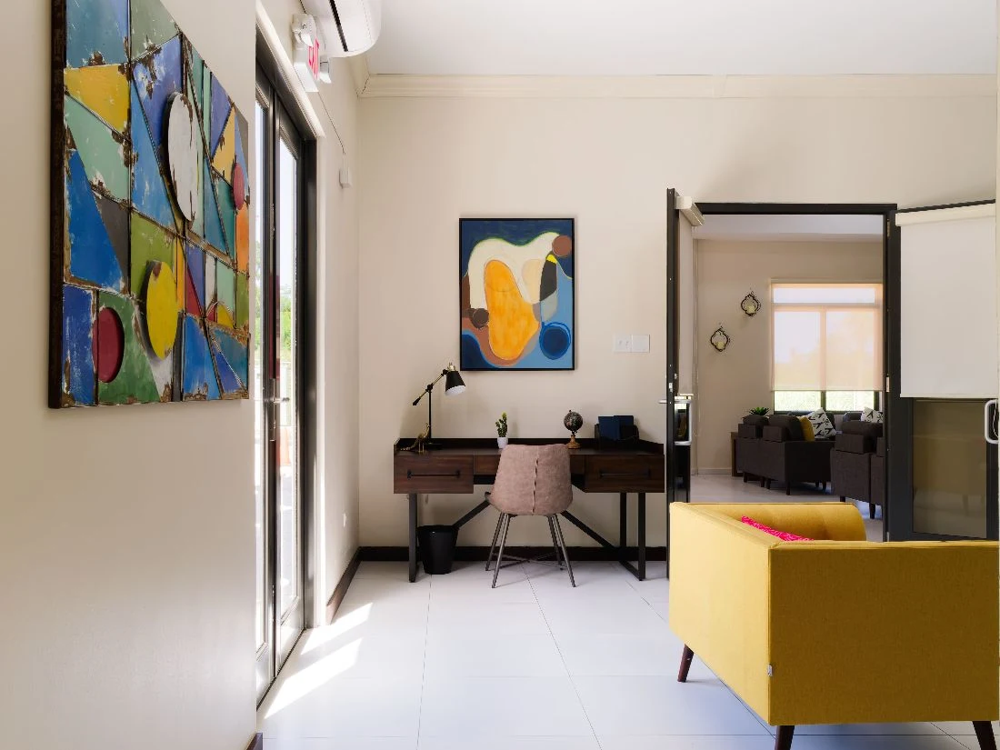 Therapy room with desk, modern artwork, and seating