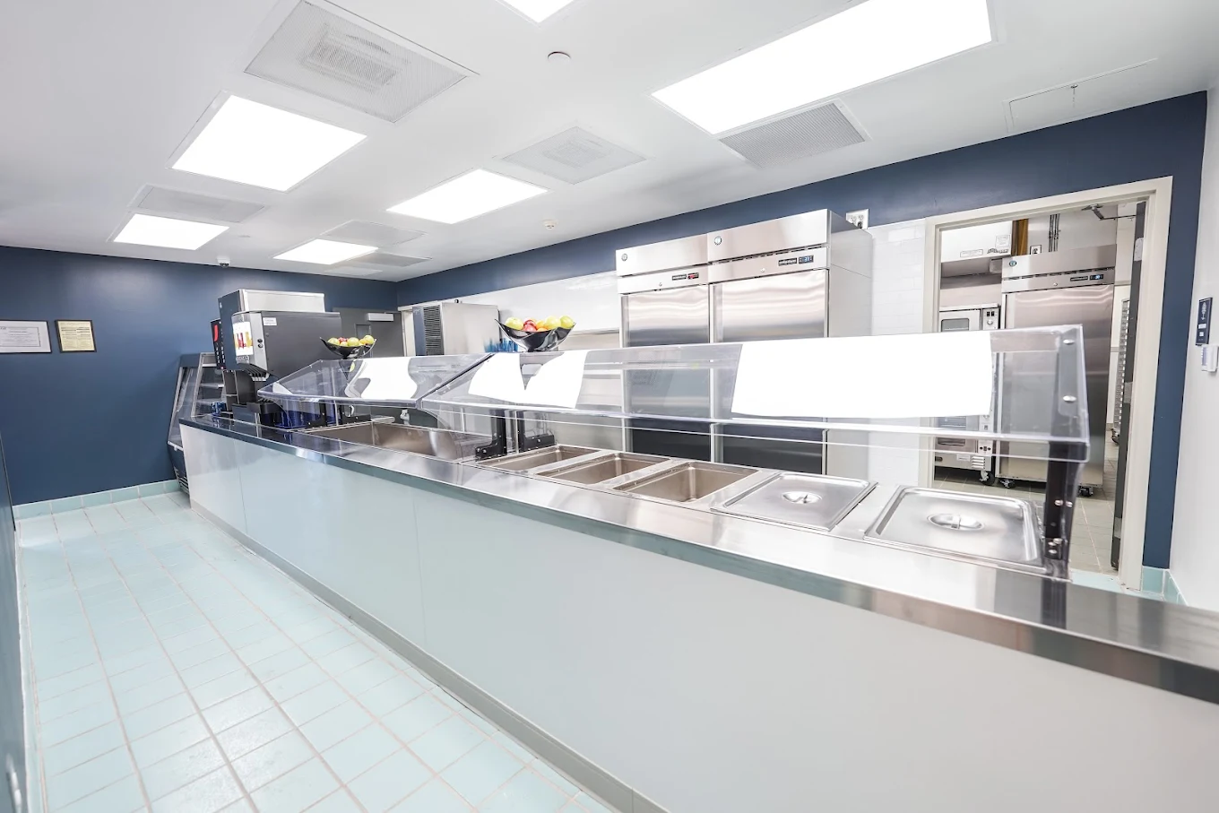 Cafeteria serving line with stainless steel food stations