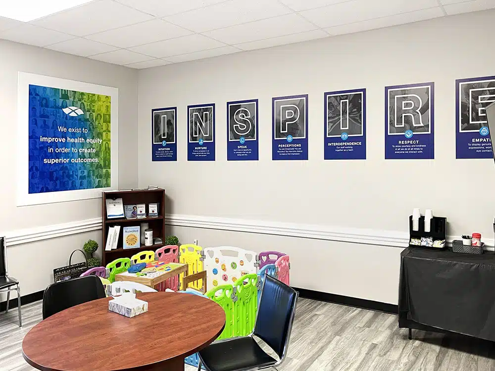 Room with table, kids play area, and wall posters