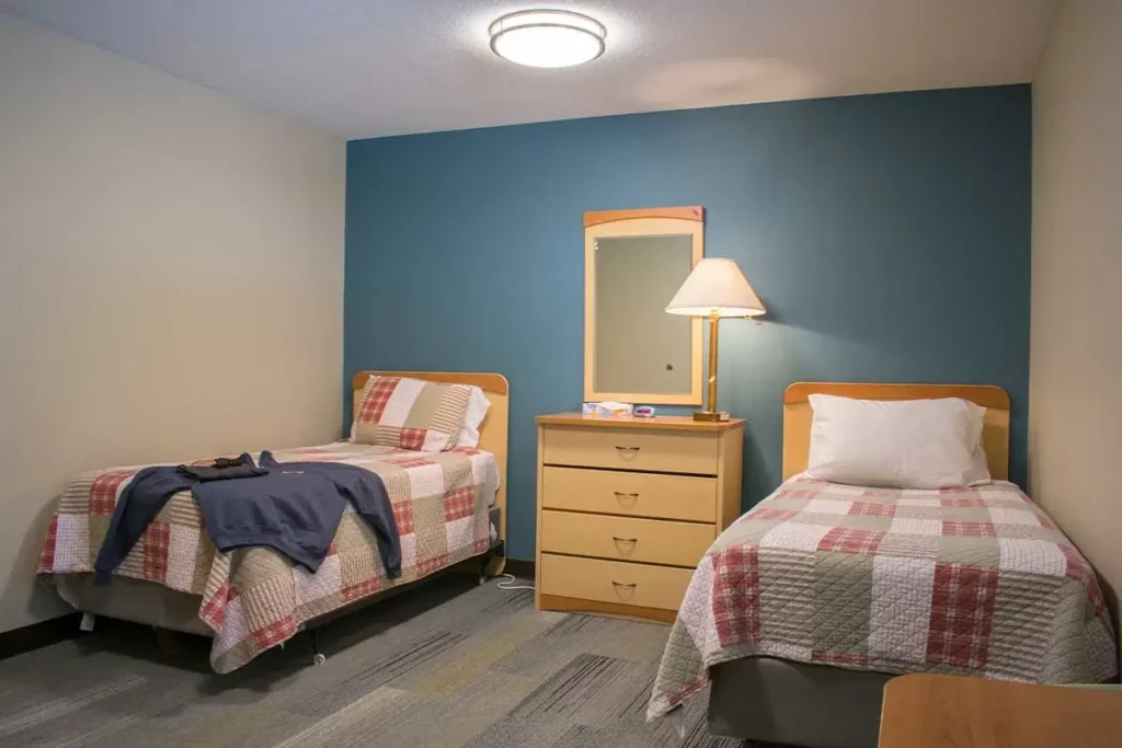 Cozy shared bedroom with two twin beds and a dresser