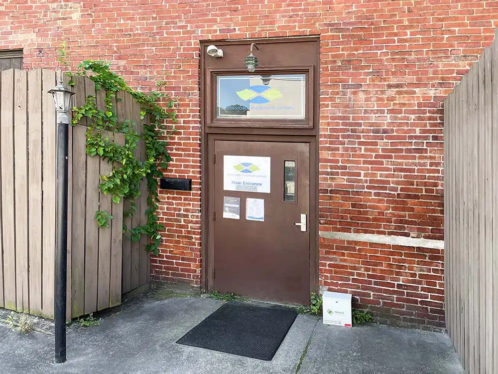 Brick building entrance with Crossroads signage on door