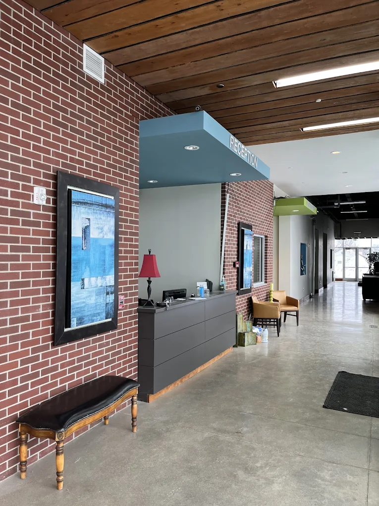 Modern reception desk with red brick wall and blue canopy