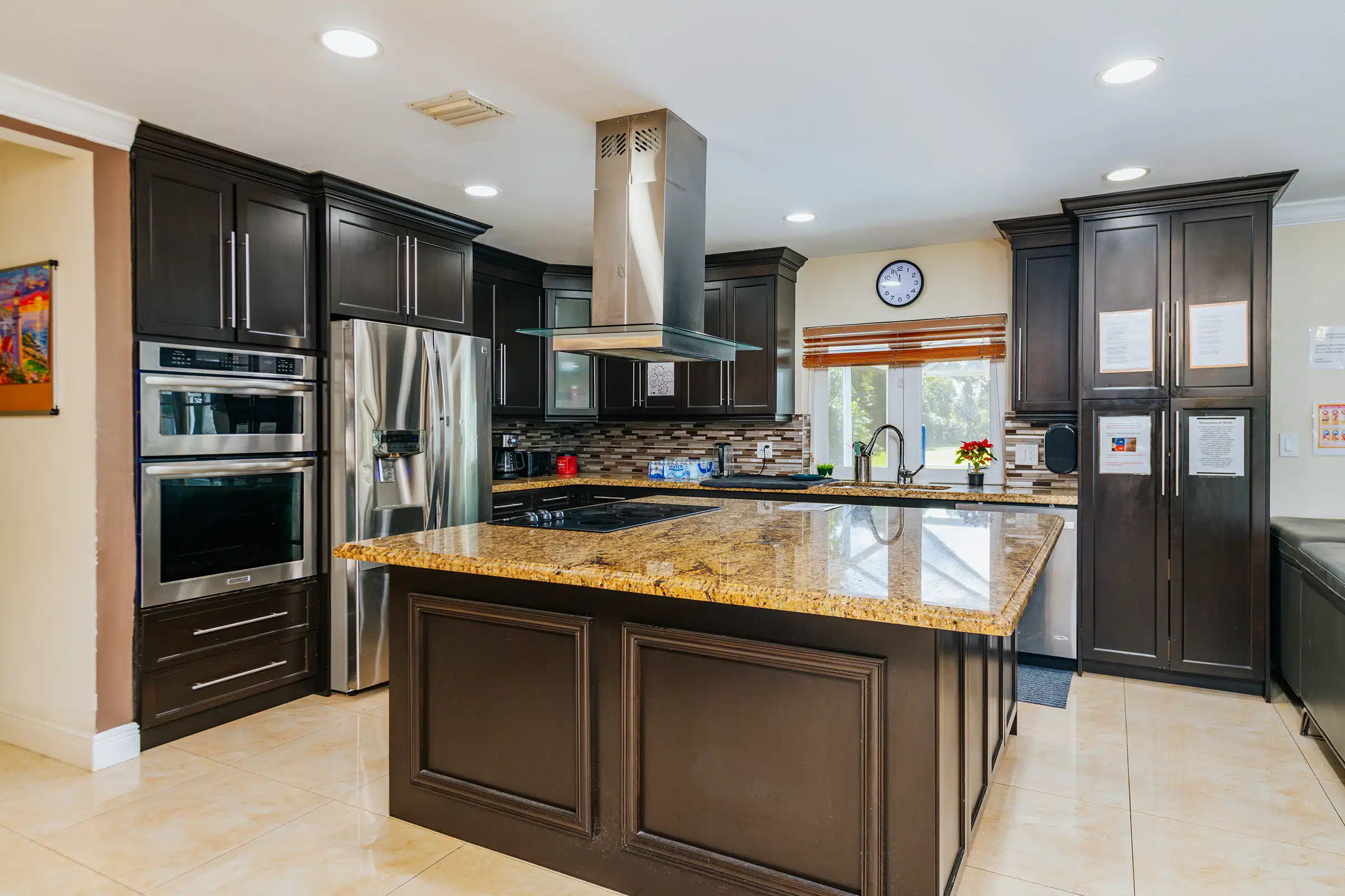 Modern kitchen with granite island and dark cabinets