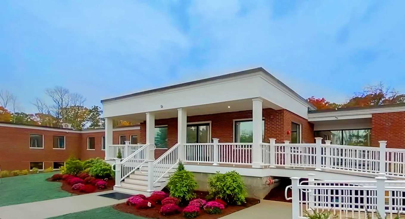 Red-brick facility with white columns and landscaped front entrance
