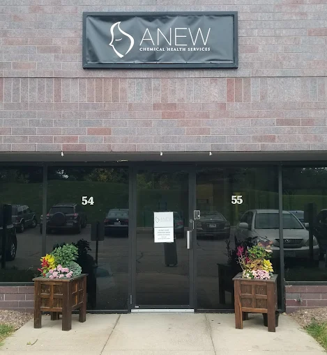 Building entrance with signage and flower planters