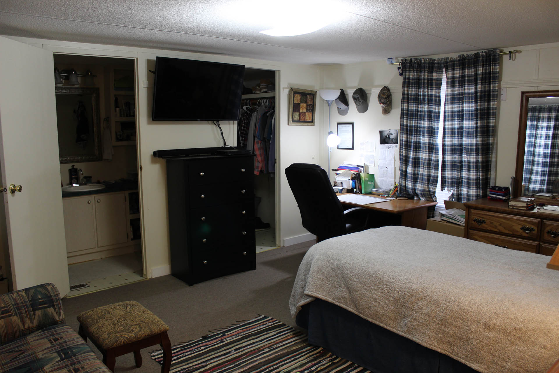Private bedroom with desk, TV, and ensuite bathroom
