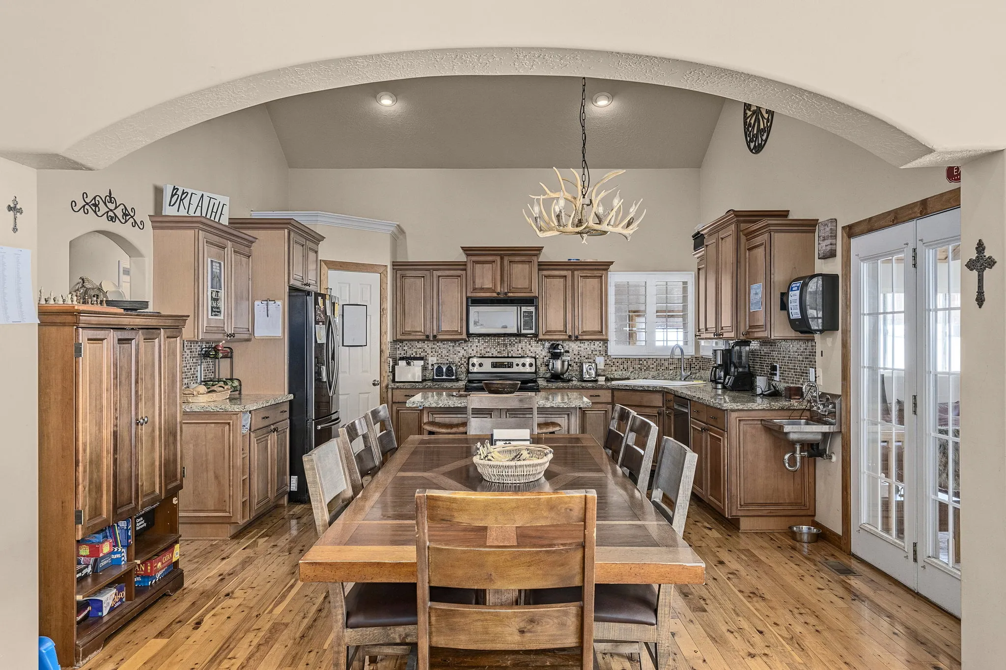 Rustic kitchen with wooden table and antler chandelier