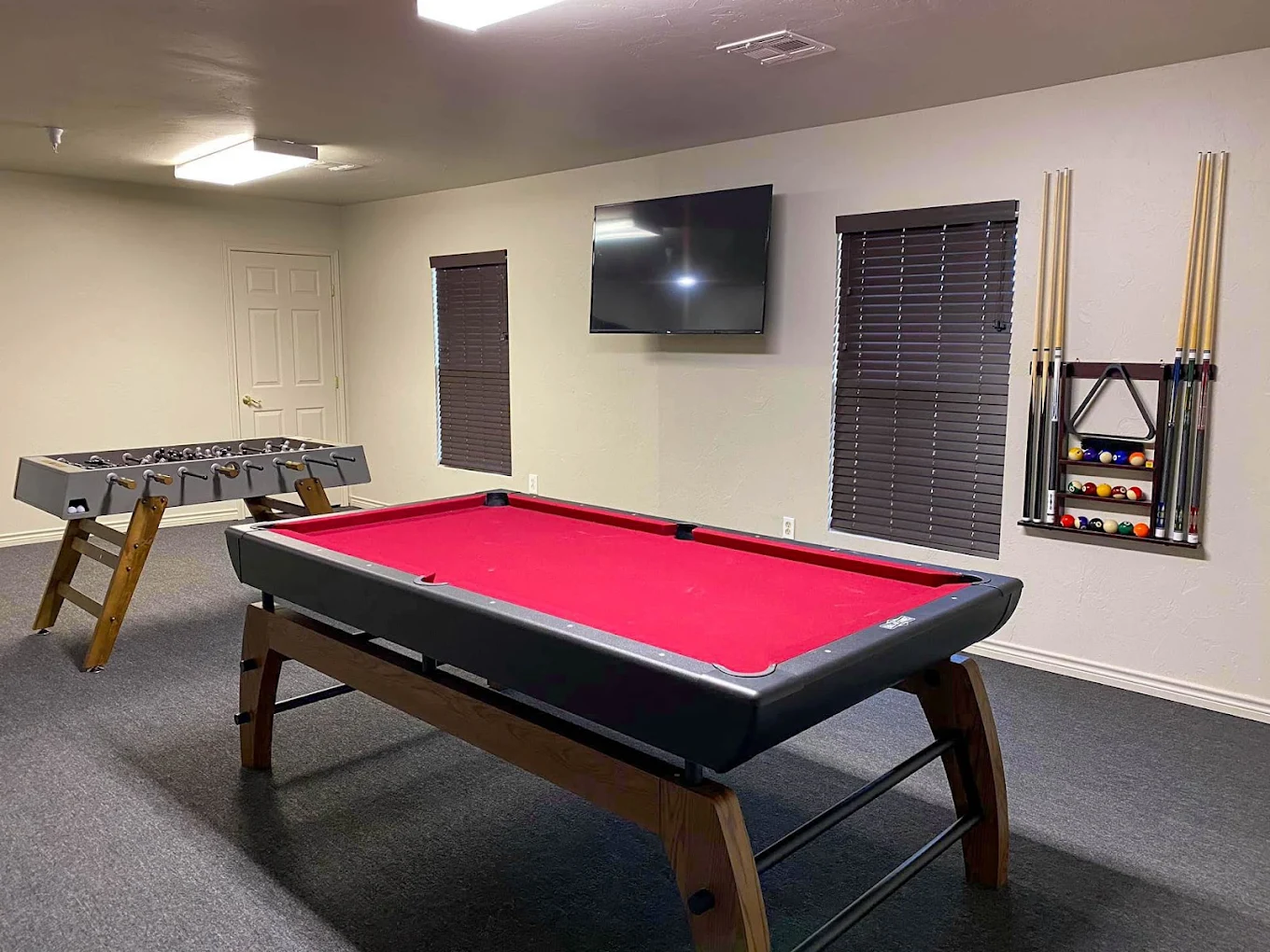 Recreation room with pool table, foosball, and TV