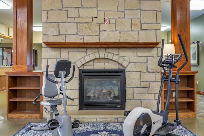 Exercise equipment near stone fireplace