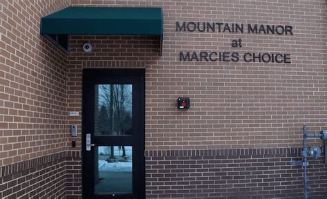 Brick exterior with door and green awning at treatment center