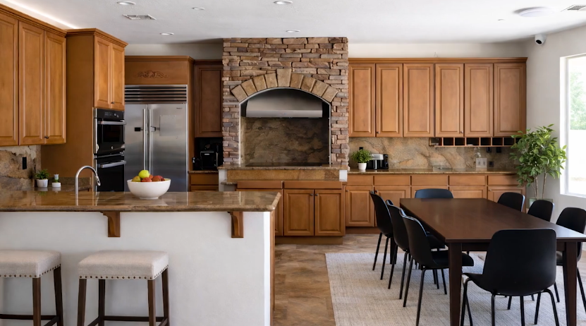 Spacious kitchen and dining area with wood cabinetry, island, and large table
