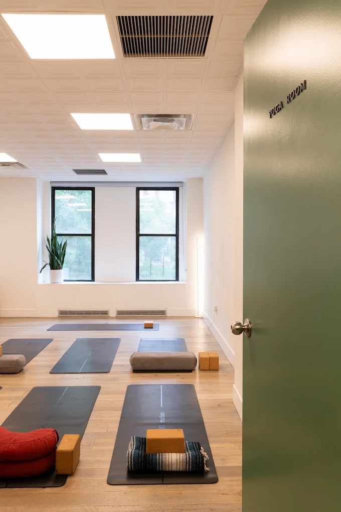Wellness room with yoga mats and meditation cushions