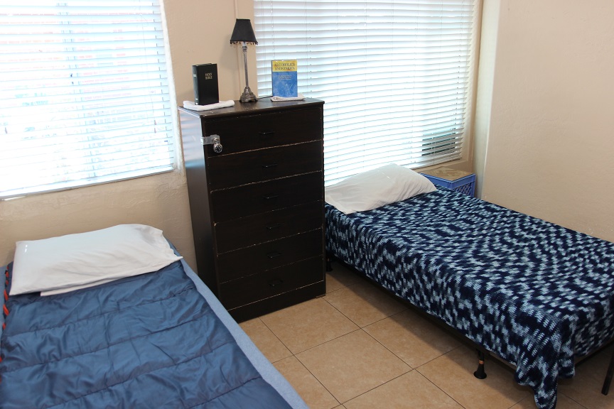 Shared bedroom with two twin beds and a tall dresser